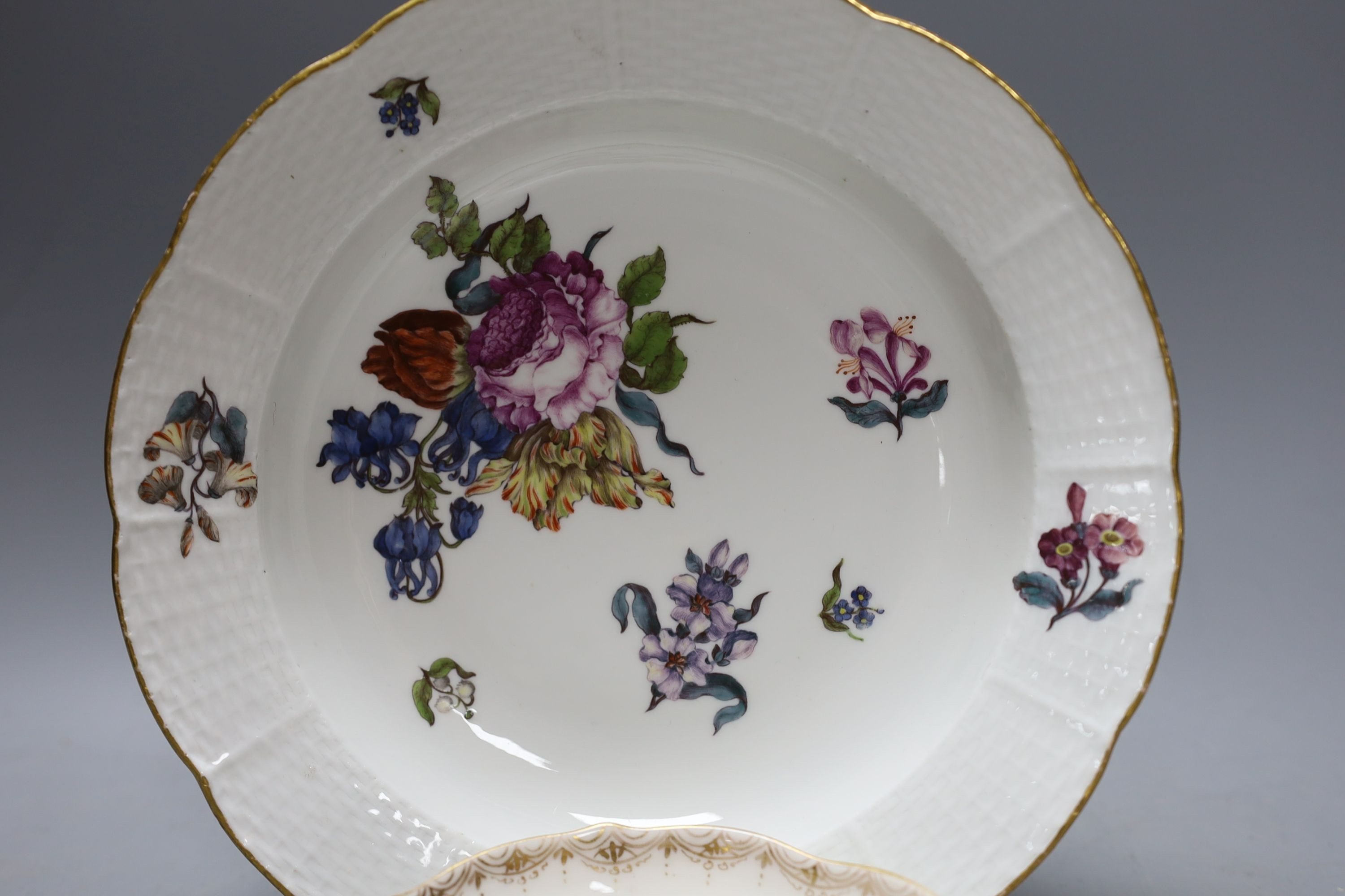 A Meissen Deutsche Blumen soup plate, c.1750 and a 19th-century Meissen outside decorated saucer (2)